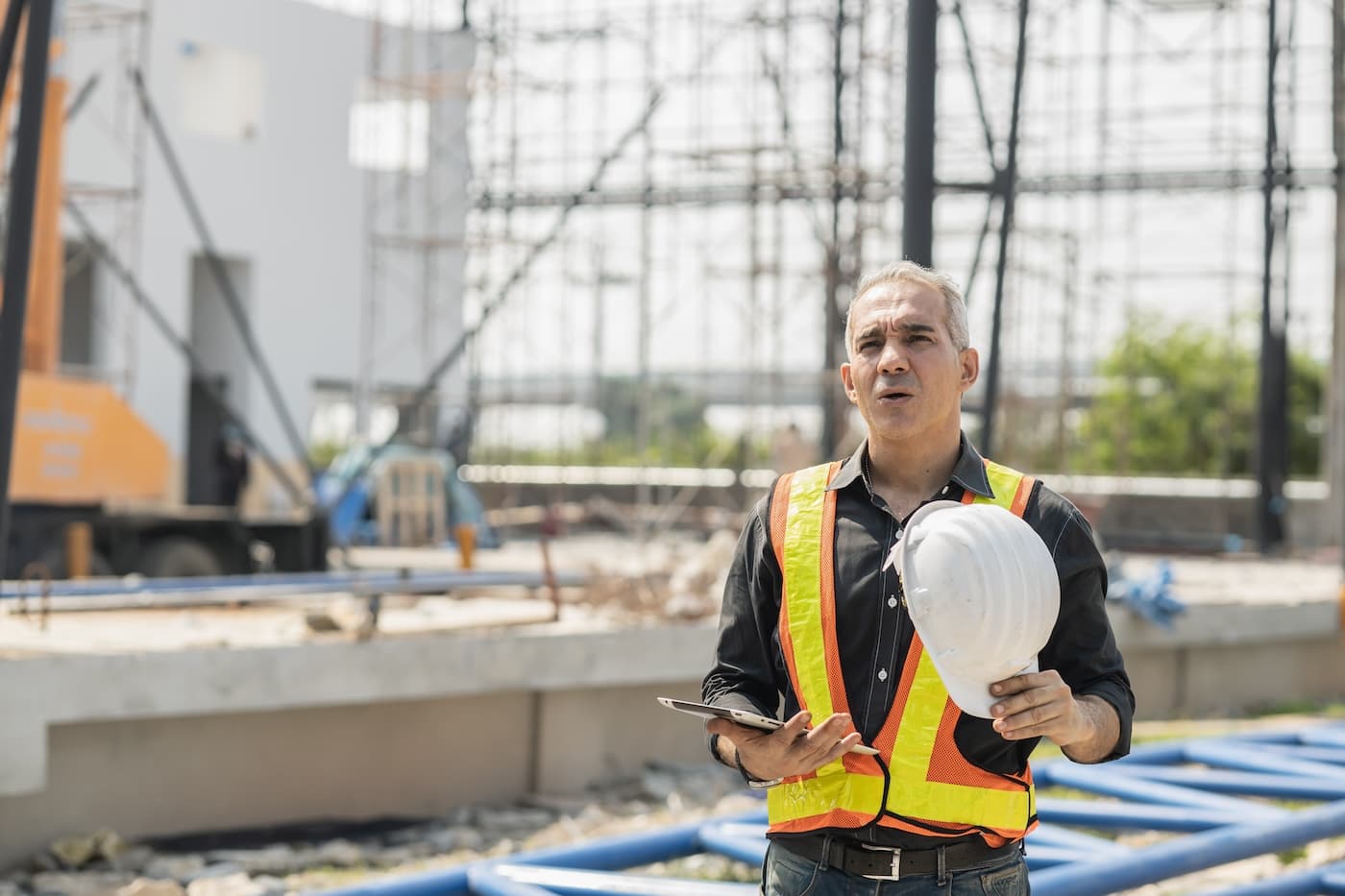 Commercial manager preparing a payment application on site
