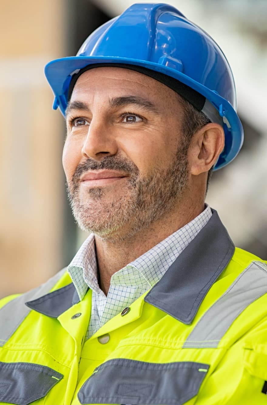 Contractor in a hard hat reviewing works on a construction site