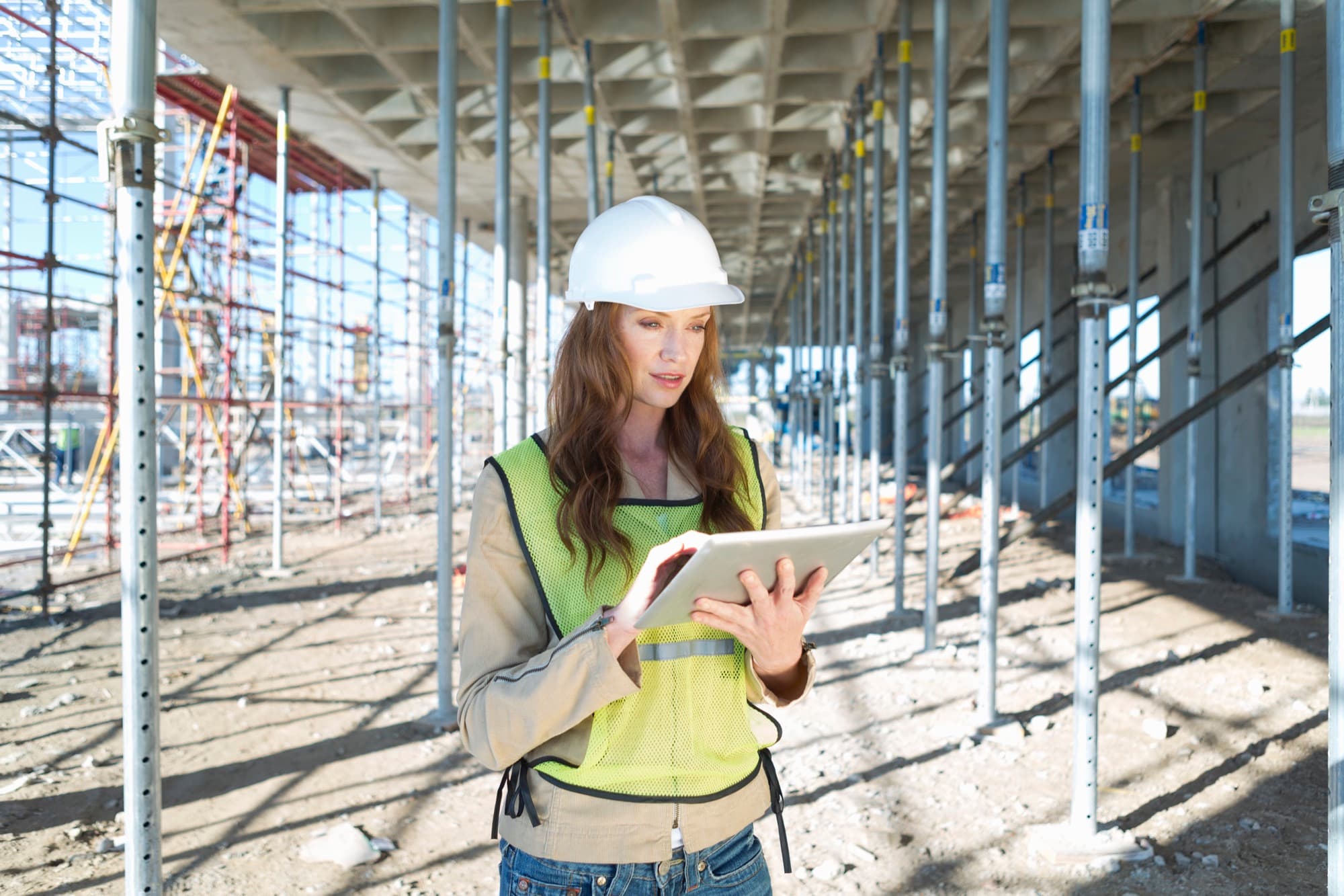 Engineer completing site records on a tablet in the field