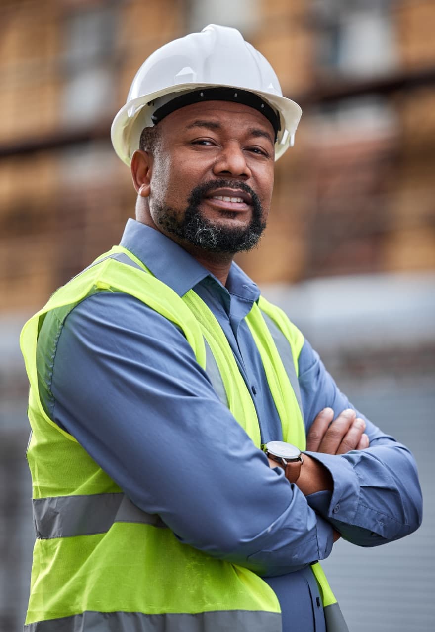 Construction manager in a hard hat and hi-vis vest on site