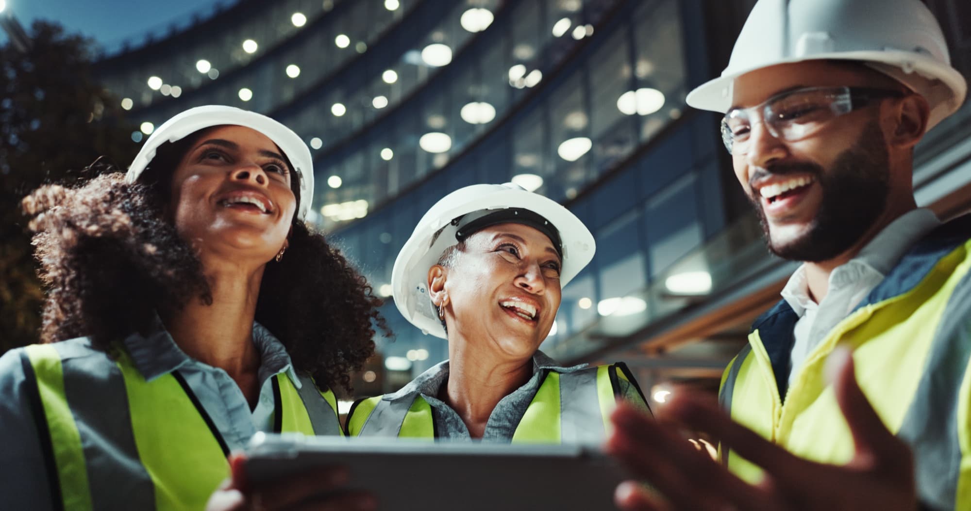 Construction team reviewing figures together on a tablet