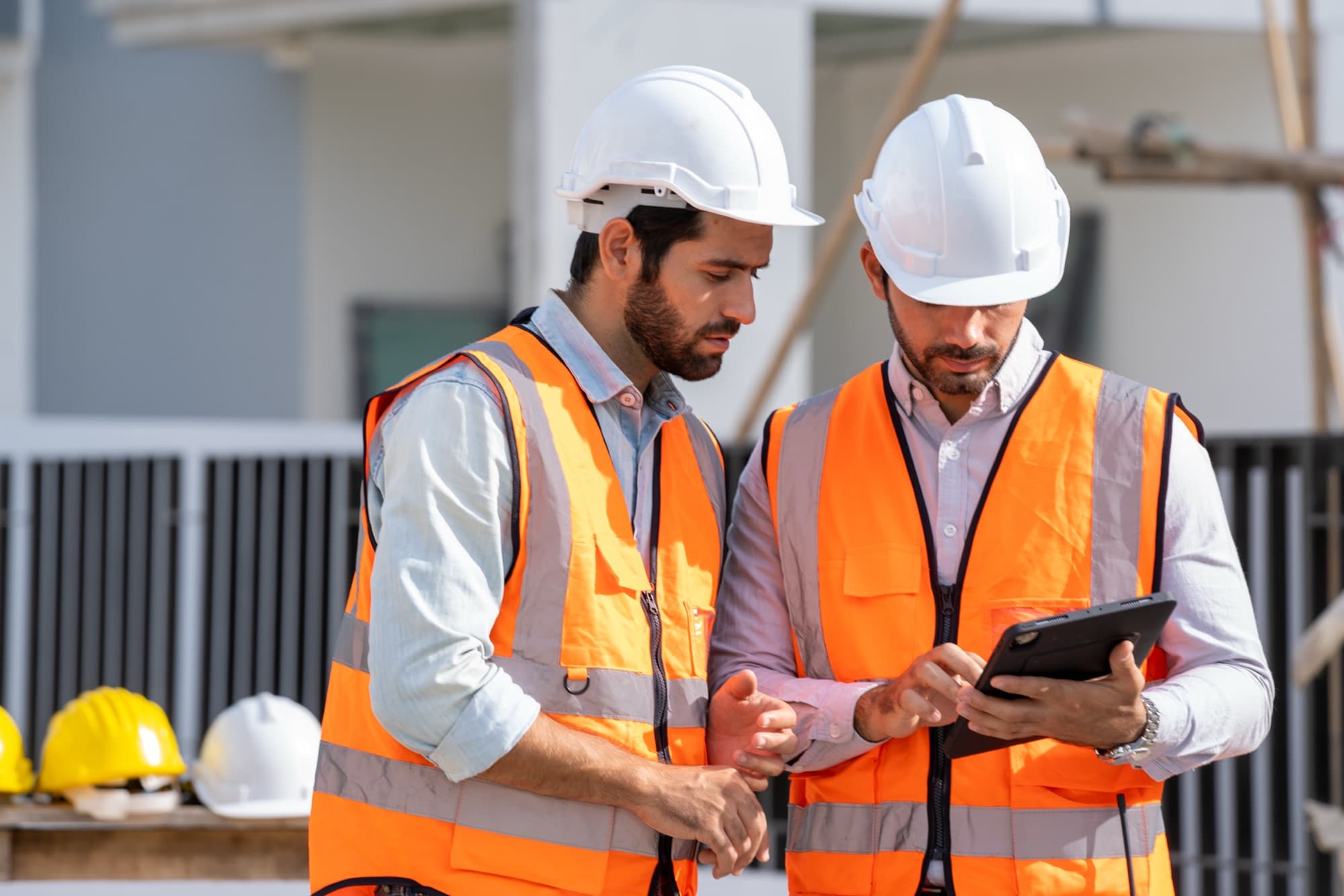 Site team reviewing plans together on a tablet