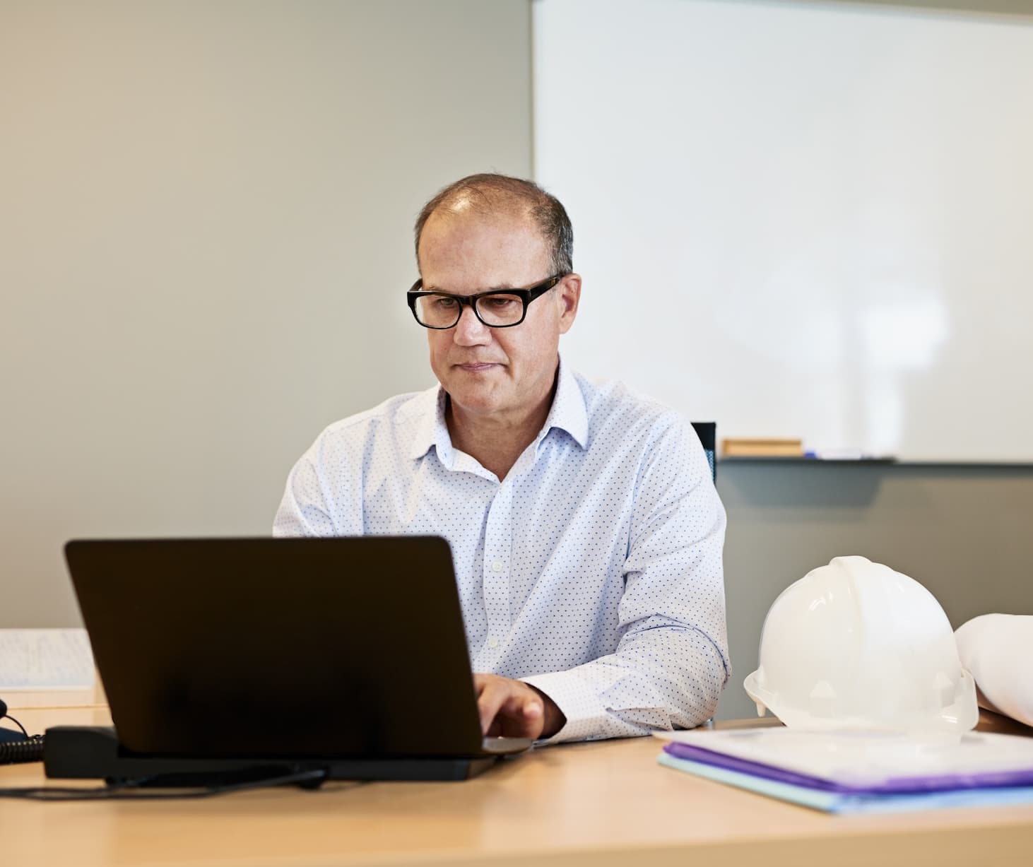 Commercial manager reviewing live project costs on a fast-track data center project
